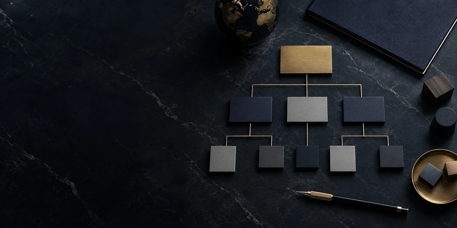 Group structure chart laid out in brass and dark tiles on black marble